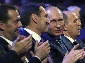 FILE In this file photo taken on Wednesday, Dec. 20, 2017, President Vladimir Putin, second right, Sergei Naryshkin, head of the Russian Foreign Intelligence Service, second left, Prime Minister Dmitry Medvedev, left, Federal Security Service (FSB) Director Alexander Bortnikov, attend meeting with intelligence officers on their professional holiday in Moscow, Russia. The Russian president's reluctance to adopt the hyperconnected world's technology might seem at odds with the wide belief that he signed off on campaign to undermine the United States via social media.