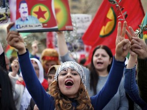 A Kurdish demonstrator chants slogans as she holds a picture of the jailed Turkish Kurdish guerrilla leader Abdullah Ocalan, during a protest against the operation by the Turkish army aimed at ousting the U.S.-backed Kurdish militia from the area in Afrin, Syria, in front of the U.S. embassy in Aukar, east Beirut, Lebanon, Monday, Feb. 5, 2018.