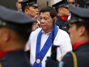Philippine President Rodrigo Duterte salutes customs police as he arrives to witness the destruction of a fleet of 20 used luxury cars and SUVs as part of the 116th anniversary celebration of the Bureau of Customs in Manila, Philippines Tuesday, Feb. 6, 2018. President Rodrigo Duterte has ordered a stop to all foreign scientific research missions in a vast expanse of waters off the country's northeast and asked navy ships and air force planes to "chase out" fishing and research vessels in the region, an official said Tuesday.