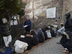 A group of college students from Israel being taught about Holocaust history at a fragment of the wall that isolated the Warsaw Ghetto and that a regional official wants to put on a list of protected historical monuments, in Warsaw, Poland, Tuesday, Feb. 20, 2018. The wall was built in 1940, when the Nazi Germans closed the area of Warsaw they called the "Jewish district."