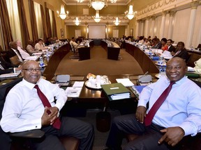 In this photo supplied by the South African Government Communications and Information Services (GCIS) South African President Jacob Zuma, left, and Deputy President Cyril Ramaphosa, right, with minsters and deputy ministers at a scheduled routine meeting of Cabinet Committees at parliament in Cape Town, South Africa, Wednesday, Feb. 7, 2018. The speaker of parliament said Tuesday that Zuma will not give the state of the nation address in parliament that had been set for Thursday and the ruling African National Congress party announced the postponement of a meeting Wednesday to discuss the president's fate.