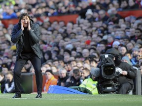 Chelsea's team manager Antonio Conte gives directions to his players during the English Premier League soccer match between Manchester United and Chelsea at the Old Trafford stadium in Manchester, England, Sunday, Feb. 25, 2018.