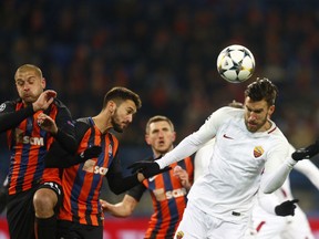 Roma's Kevin Strootman, right jumps for the ball during the Champions League, round of 16, first-leg soccer match between Shakhtar Donetsk and Roma at the Metalist Stadium in Kharkiv, Ukraine, Wednesday, Feb. 21, 2018.