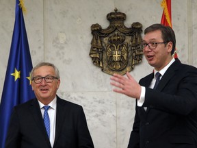 European Commission President Jean-Claude Juncker, left, speaks with Serbia's President Aleksandar Vucic in Belgrade, Serbia, Monday, Feb. 26, 2018. Juncker is on a Western Balkans tour that also includes stops in Albania, Serbia, Kosovo, Bosnia and Montenegro, all countries aspiring to EU membership.