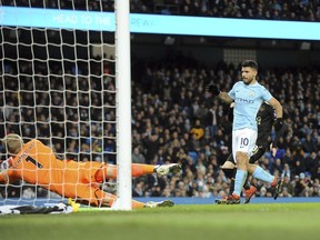 Manchester City's Sergio Aguero, right, scores his side's second goal during the English Premier League soccer match between Manchester City and Leicester City at the Etihad Stadium in Manchester, England, Saturday, Feb. 10, 2018.