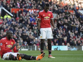 Manchester United's Romelu Lukaku, left, applauds during the English Premier League soccer match between Manchester United and Chelsea at the Old Trafford stadium in Manchester, England, Sunday, Feb. 25, 2018.