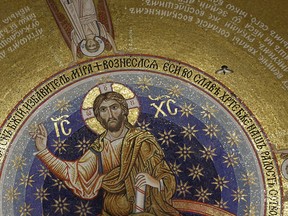 In this photo taken on Thursday, Feb. 22, 2018, a pigeon flies under the mosaic -depicting Jesus Christ, during a ceremony unveiling a new mosaic work from Russia in the St. Sava Serbian Orthodox temple in Belgrade, Serbia. Russia mainly wants to discourage Western Balkan countries from joining NATO, but has also shown opposition to their EU membership bids. Serbia is a major target for Russian efforts because of deep cultural and historic links between the two Slavic nations.