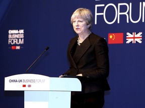 In this photo released by China's Xinhua News Agency, British Prime Minister Theresa May speaks at the China-UK Business Forum in Shanghai, Friday, Feb. 2, 2018. Chinese President Xi Jinping touted the advantages of his "Belt and Road" mega-plan for trade and infrastructure links across Asia in a meeting Thursday with British Prime Minister Theresa May, whose government has been slow to endorse the initiative.