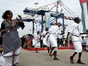 In this Feb. 7, 2009 file photo, Djibouti men and women dance during the opening ceremony of Dubai-based port operator DP World's Doraleh container terminal in Djibouti port. Djibouti has seized control of the terminal run by DP World, the latest move in a long-running legal dispute between the East African nation and DP World over the facility.