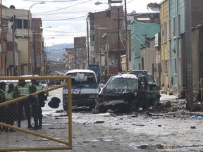 Police stand guard at the site of an explosion in Oruro, Bolivia, Thursday, Feb. 15, 2018. Bolivian officials said Wednesday that a bomb was what caused the explosion that killed four people during Carnival celebrations in Oruro.