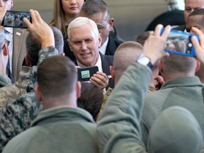 U.S. Vice President Mike Pence takes a selfie with the U.S. troops at the U.S. Yokota Air Base, on the outskirts of Tokyo, Thursday, Feb. 8, 2018.