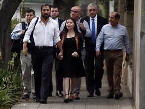 Isaac Givovich, left, holds hands with his wife as they arrive with group of the Marist congregation to give testimony to Archbishop Charles Scicluna as part of a child sex abuse investigation in Santiago, Chile, Tuesday, Feb. 27, 2018. Scicluna, an envoy sent by Pope Francis, is gathering testimonies regarding Bishop Juan Barros allegedly covering up sexual abuses committed by Vatican-condemned priest Fernando Karadima.
