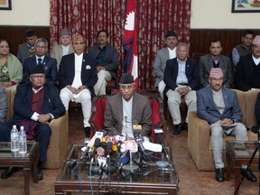Nepalese Prime Minister Sher Bahadur Deuba, center, announces his resignation in Kathmandu, Nepal, Thursday, Feb. 15, 2018. Deuba, whose Nepali Congress party lost parliamentary elections, resigns paving way for a new government to take over power.
