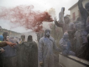 Revelers throw flour as they participate in the flour war, a unique colorful flour fight marking the end of the carnival season, in the port town of Galaxidi, some 200 kilometers (120 miles) west of Athens, Monday, Feb. 19, 2018. The flour fight, on the coastal road lining Galaxidi's old harbor, takes place on Clean Monday, the beginning of the 40-day Christian Lent fast that ends on Easter Sunday.