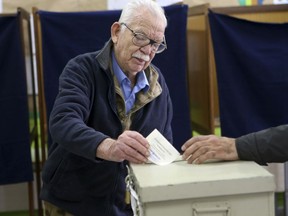 An elderly man votes during the presidential elections in south coastal city of Limassol, Cyprus, on Sunday, Feb. 4, 2018. Cypriots will vote in the second round for the new president with critical topics including the reunification of the divided island and economic recovery.