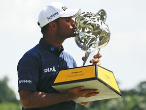 India's Shubhankar Sharma kisses his trophy after winning the Maybank Championship golf tournament in Shah Alam, Malaysia, Sunday, Feb. 4, 2018.