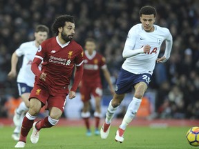 Liverpool's Mohamed Salah, left, Tottenham's Dele Alli run for the ball during the English Premier League soccer match between Liverpool and Tottenham Hotspur at Anfield, Liverpool, England, Sunday, Feb. 4, 2018.