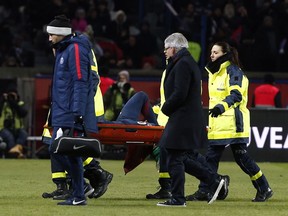 PSG's Neymar leaves the pitch on a stretcher after being injured during the French League One soccer match between Paris Saint-Germain and Marseille at the Parc des Princes Stadium, in Paris, France, Sunday, Feb. 25, 2018.