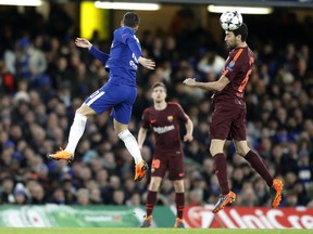 Barcelona's Sergio Busquets, right, heads the ball as Chelsea's Eden Hazard tries to stop him during the Champions League, round of 16, first-leg soccer match between Chelsea and Barcelona at Stamford Bridge stadium, Tuesday, Feb. 20, 2018.
