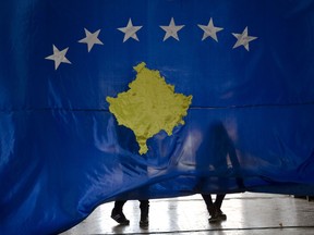 Students lift the flag of Kosovo during an independence celebration ceremony at the Hasan Zyko Kamberi school in the village of Sllovi near the town of Lipjan, Kosovo on Friday Feb. 16, 2018, ahead of the upcoming 10th independence anniversary. A student of the school, Pavaresia Sopi, 10, was the first child born after Kosovo declared independence from Serbia in 2008. Pavaresia translates in English as "Independence".