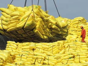 A worker walks on goods waiting to be exported in a port in Lianyungang, east China's Jiangsu province.