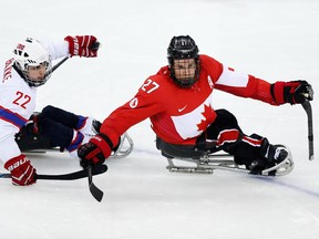 In this March 15, 2014 file photo, Brad Bowden (right) competes against Norway in the bronze-medal game at the Sochi Paralympics.