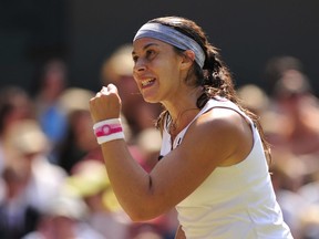 France's Marion Bartoli celebrates a point against Germany's Sabine Lisicki in their women's singles final at Wimbledon in 2013.