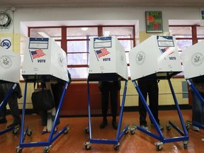 Voters cast their ballots at voting booths at The Straus School on November 8, 2016 in New York, United States.