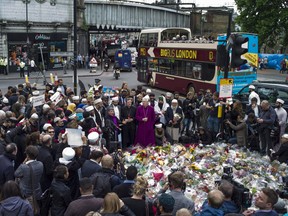 Imams and members of the Muslim community arrive to lay flowers near the scene of the London Bridge terrorist attacks, on June 7, 2017 in London, England.