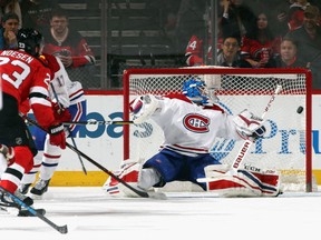 Stefan Noesen of the New Jersey Devils scores in the first period against goaltender Charlie Lindgren of the Montreal Canadiens on Tuesday night at the Prudential Center in Newark, N.J.