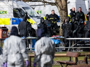 Police officers in protective suits and masks work near the scene where former double-agent Sergei Skripal and his daughter, Yulia were discovered after being attacked with a nerve-agent on March 16, 2018 in Salisbury, England.