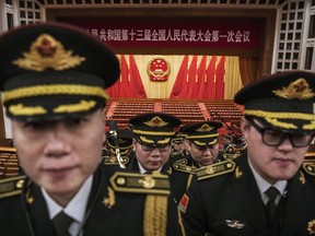 Members of a band from the People's Liberation Army leave following a speech by China's President Xi Jinping after the closing session of the National People's Congress at The Great Hall Of The People on March 20, 2018 in Beijing, China.