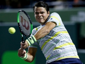 Milos Raonic of Canada returns a shot against Juan Martin del Potro of Argentina on Wednesday night during their quarter-final match at the Miami Open at Crandon Park Tennis Center in Key Biscayne, Fla.