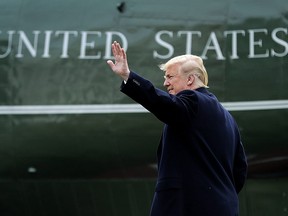 U.S. President Donald Trump waves to guests on the South Lawn before departing the White House March 29, 2018 in Washington, DC.