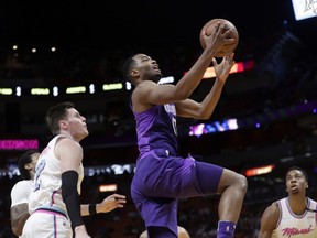 Phoenix Suns' TJ Warren, center, drives past Miami Heat's Luke Babbitt, left, and Hassan Whiteside, right, during the first half of an NBA basketball game, Monday, March 5, 2018, in Miami.