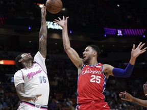 Miami Heat's James Johnson (16) blocks a shot by Philadelphia 76ers' Ben Simmons (25) during the first half of an NBA basketball game Thursday, March 8, 2018, in Miami.