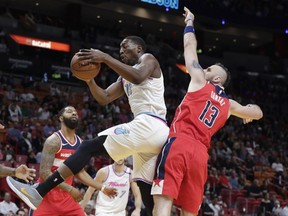 Miami Heat's Bam Adebayo, front left, gets a rebound over Washington Wizards' Marcin Gortat (13) during the first half of an NBA basketball game, Saturday, March 10, 2018, in Miami.