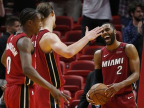 Miami Heat guard Wayne Ellington (2), forward Kelly Olynyk, center, and guard Josh Richardson (0) celebrate after they defeated the Denver Nuggets in double overtime of an NBA basketball game, Monday, March 19, 2018, in Miami.