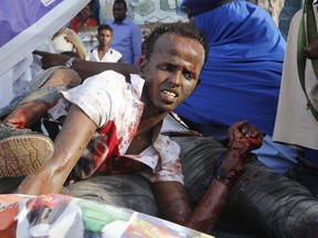 An injured civilian who was wounded during a car bombing in Mogadishu, Somalia Thursday, March 22, 2018. Somali officials say at least 14 people have been killed and 10 others are wounded in a car bomb blast near a hotel in the capital, Mogadishu. Capt. Mohamed Hussein says the explosion occurred near the Weheliye hotel on the busy Makka Almukarramah Road. The road has been a target of attacks in the past by the Somalia-based extremist group al-Shabab.