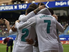 Real Madrid's Cristiano Ronaldo celebrates his second goal beside Lucas Vazquez and Daniel Carvajal after scoring during the Spanish La Liga soccer match between Real Madrid and SD Eibar at Ipurua stadium, in Eibar, northern Spain, Saturday, March10, 2018.