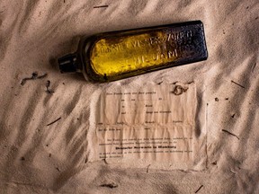 This undated photo received courtesy from Kym Illman on March 7, 2018 shows a bottle and the  almost 132-year-old message it contained, that was found near Wedge Island.