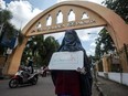 A student wearing a niqab face veil stages a protest against the ban on wearing niqabs on university grounds at the Sunan Kalijaga State Islamic University in Yogyakarta on March 8, 2018.