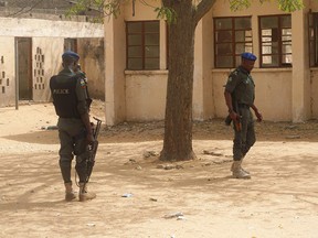 In this file photo taken on February 28, 2018 policemen stand on guard at the premises of Government Girls Technical College, where 110 girls were kidnapped by Boko Haram Islamists at Dapchi town in northern Nigerian.