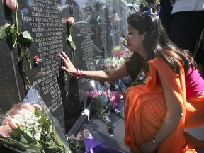 A mourner visits a Toronto memorial to the 329 people who died in the bombing of Air India Flight 182.