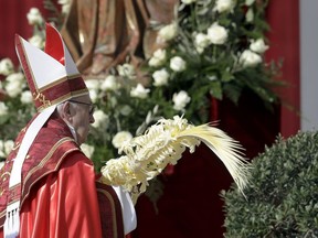 Pope Francis celebrates a Palm Sunday Mass in St. Peter's Square at the Vatican, Sunday, March 25, 2018.