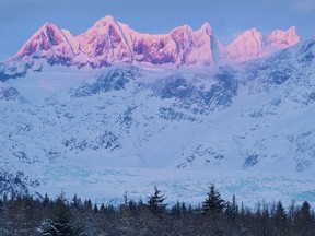 FILE - In this Dec. 2012 file photo, the last rays of sunlight catch the Mendenhall Towers as seen from Brotherhood Bridge Park in Juneau, Alaska. Two experienced mountain climbers trying to tackle a new route in Alaska were presumed dead after climbing ropes that matched their gear were found in a crevasse, authorities said Wednesday, March 14, 2018. George "Ryan" Johnson, 34, of Juneau, and Marc-Andre Leclerc, 25, of Squamish, British Columbia, were reported missing after they failed to return from a climb March 7 on the Mendenhall Towers, a seven-peaked mountain not far from Alaska's capital city.