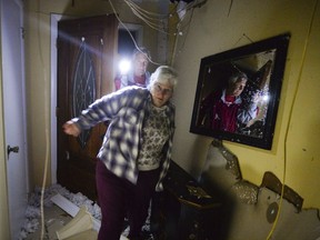 Homeowner Michael Shell, background, walks into his destroyed home with his sister Theresa Wagoner after a possible tornado touched down on Gatlin Road in Ardmore, Ala., Monday March 19, 2018.  Severe storms that spawned tornadoes damaged homes and downed trees as they moved across the Southeast on Monday night.