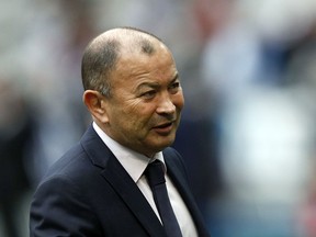 FILE - In this Saturday, March 10, 2018 file photo, England's head coach Eddie Jones gestures as he watches his team warm up prior to the start of the Six Nations rugby union match between France and England at the Stade de France stadium in Saint-Denis, outside Paris.  Jones has apologized for making derogatory remarks about Ireland and Wales during a sponsorship event in Japan last year.