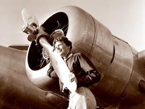 This May 20, 1937 photo, provided by The Paragon Agency, shows aviator Amelia Earhart with her Electra plane's propeller, taken by Albert Bresnik at Burbank Airport in Burbank, Calif.
