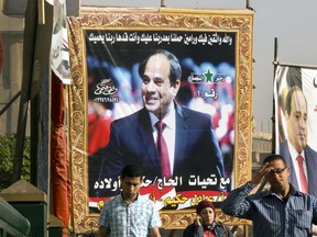 An election campaign banner for Egyptian President Abdel-Fattah el-Sissi, hangs in Opera Square, in Cairo, Egypt, Thursday, March 22, 2018. President Abdel-Fattah el-Sissi, the general-turned-president, will stand for re-election next week against Moussa, a little-known politician who has made no effort to challenge him. Arabic reads, "We swear, we trust you and we are throwing our issues on you after God and we believe  you are able to do it, God bless you."